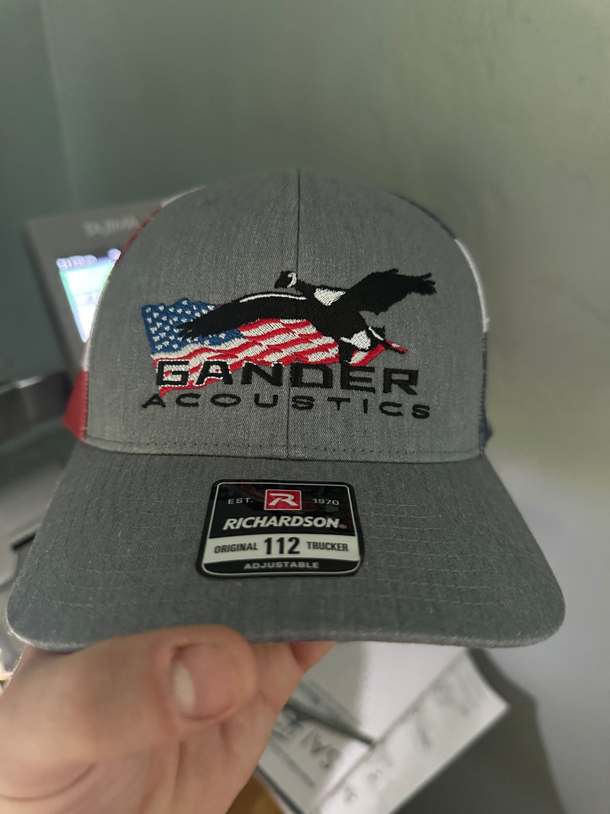 Gray hat with custom embroidery stitched by Qwik Tees in DeLand FL, showcasing local logo design and detailed stitching.