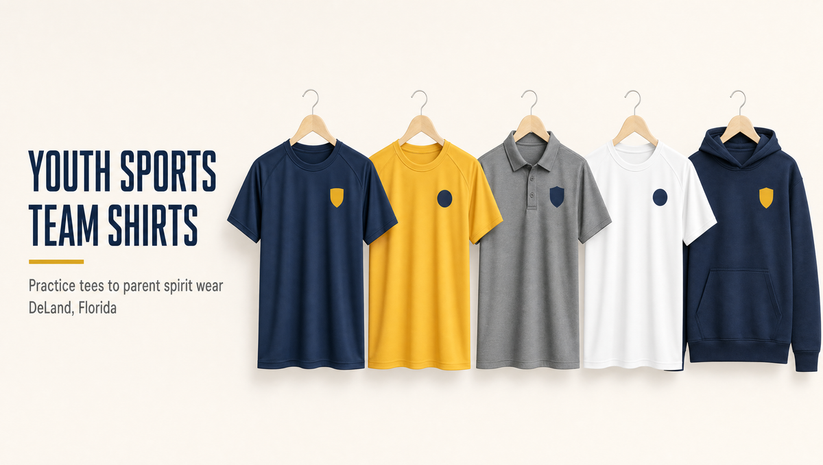 Navy, gold, grey and white youth sports team shirts hanging in a row