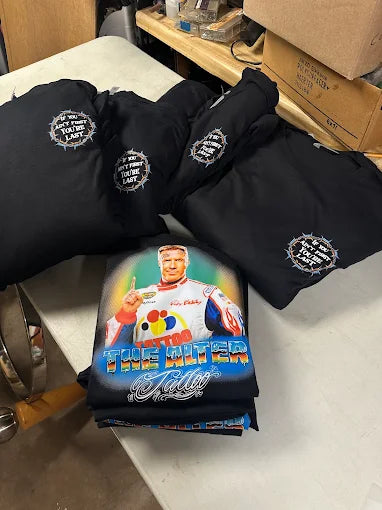 Bulk order of custom printed work t-shirts stacked and ready for delivery from Qwik Tees in DeLand, Florida.