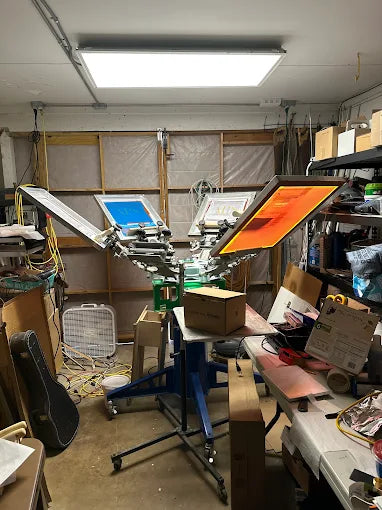 A professional screen embroidery machine printing custom work shirts for schools and businesses in DeLand and Volusia County.